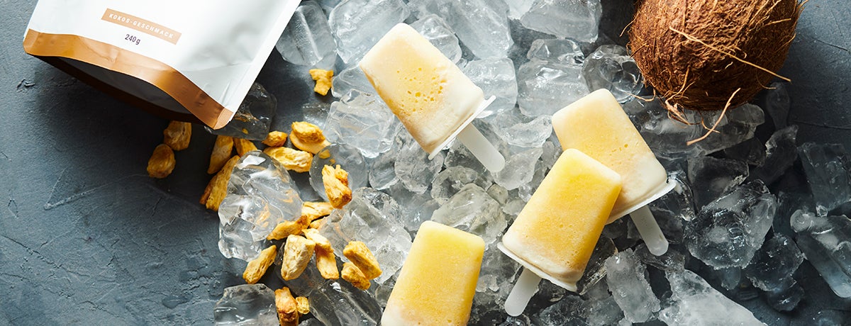 Coconut and pineapple ice cream pops on a bed of ice cubes
