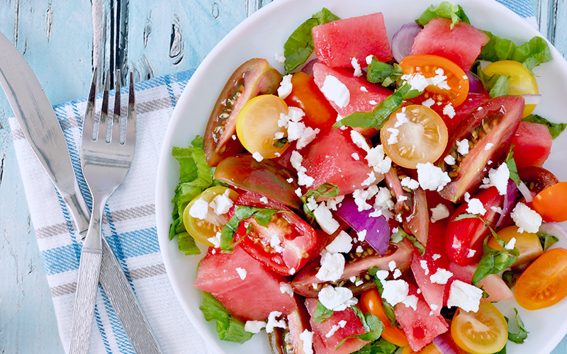 A colorful salad of quartered tomatoes and crumbled feta with a purple onion is a great idea for changing your diet