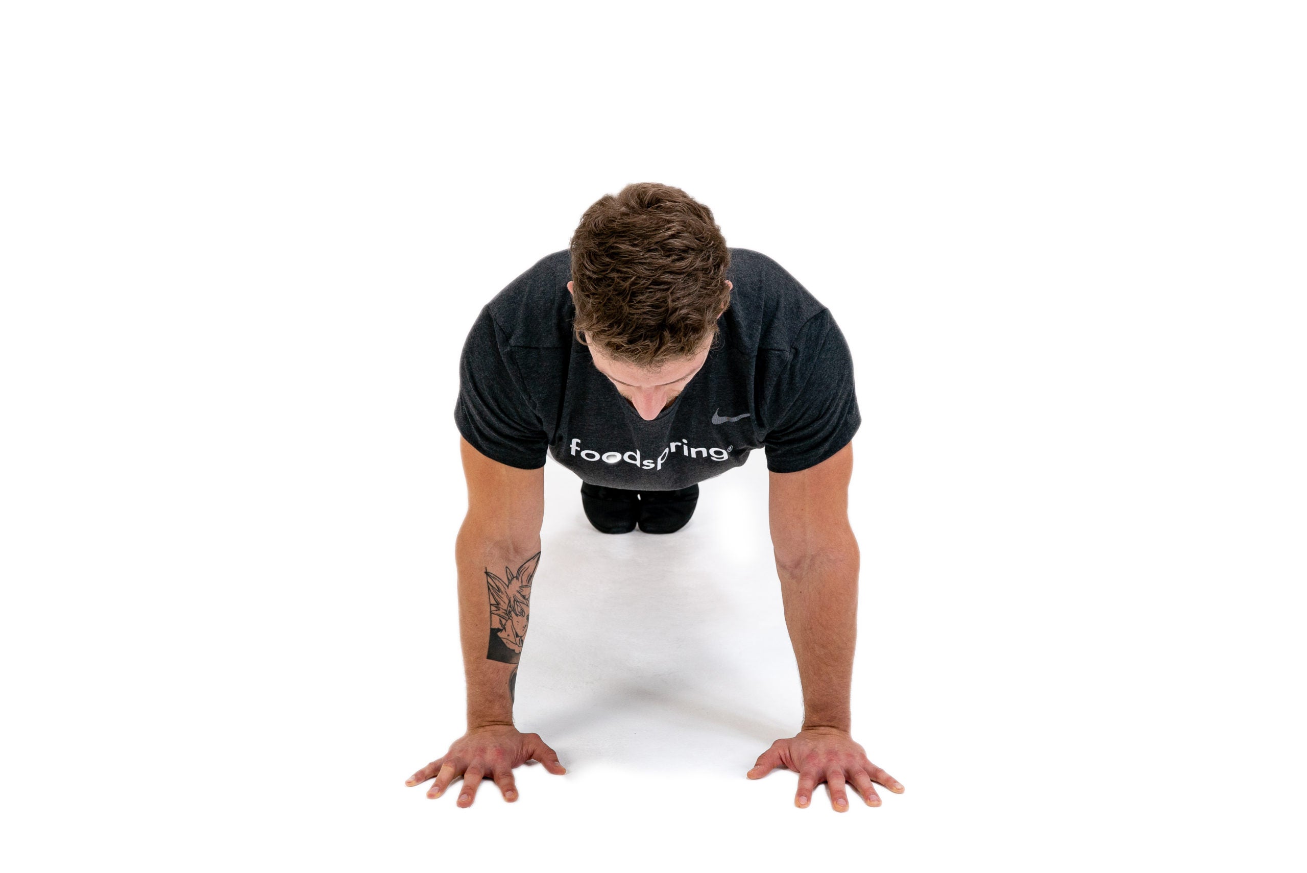 A white athlete performs a close-grip push-up
