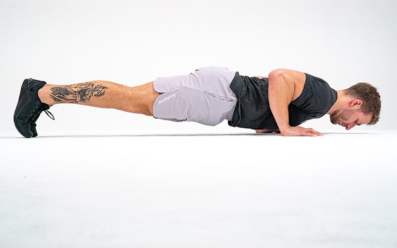 A white man does push-ups as part of his full body workout plan