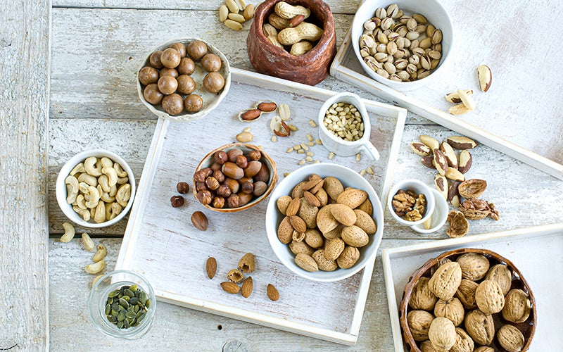 a photo of nuts in various bowls, as a good source of zinc