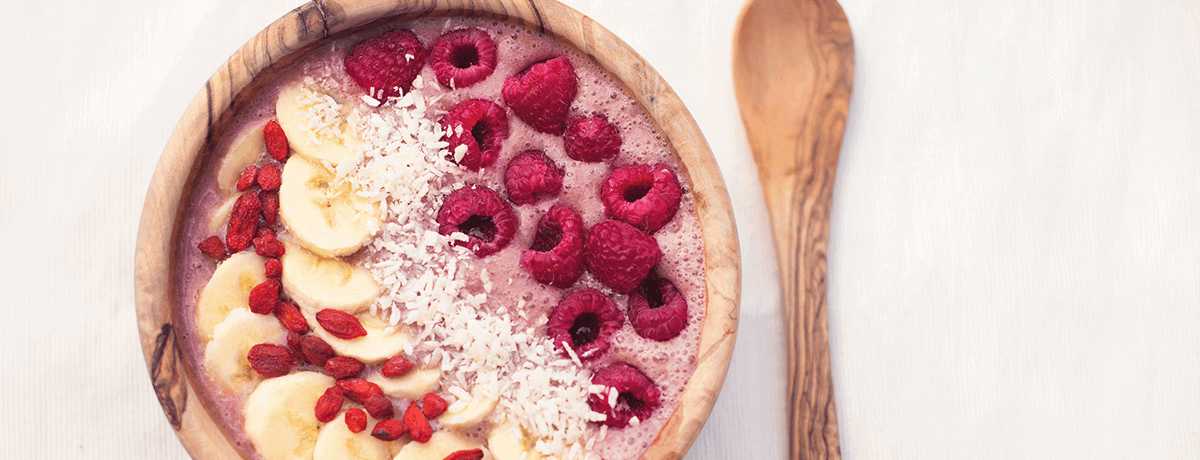 A photo of a berry smoothie bowl. Too little protein intake is one of 5 top muscle-building mistakes, and our smoothie bowl can help you get more protein.