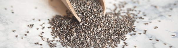 a wooden scoop overflowing with chia seeds shows the benefits of chia seeds