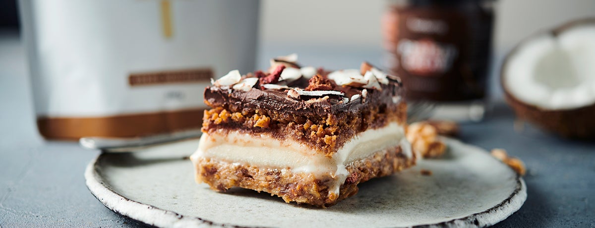 a five-layer protein ice cream cake sits on a plate