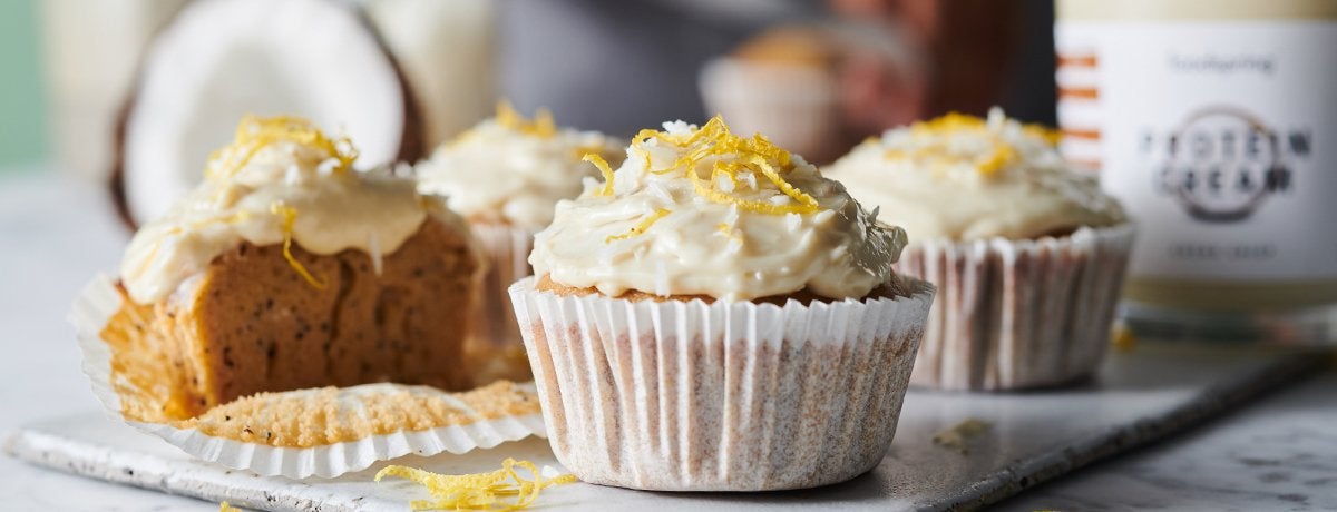 A plate of coconut-lemon protein cupcakes made with Coconut Crisp Protein Cream
