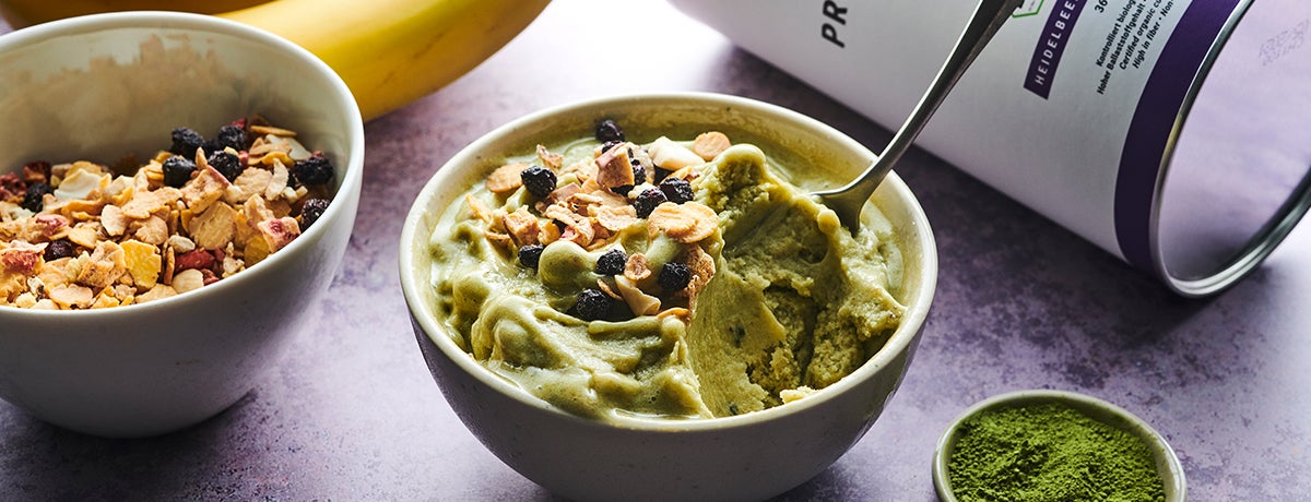 A bowl of matcha nice cream topped with protein muesli