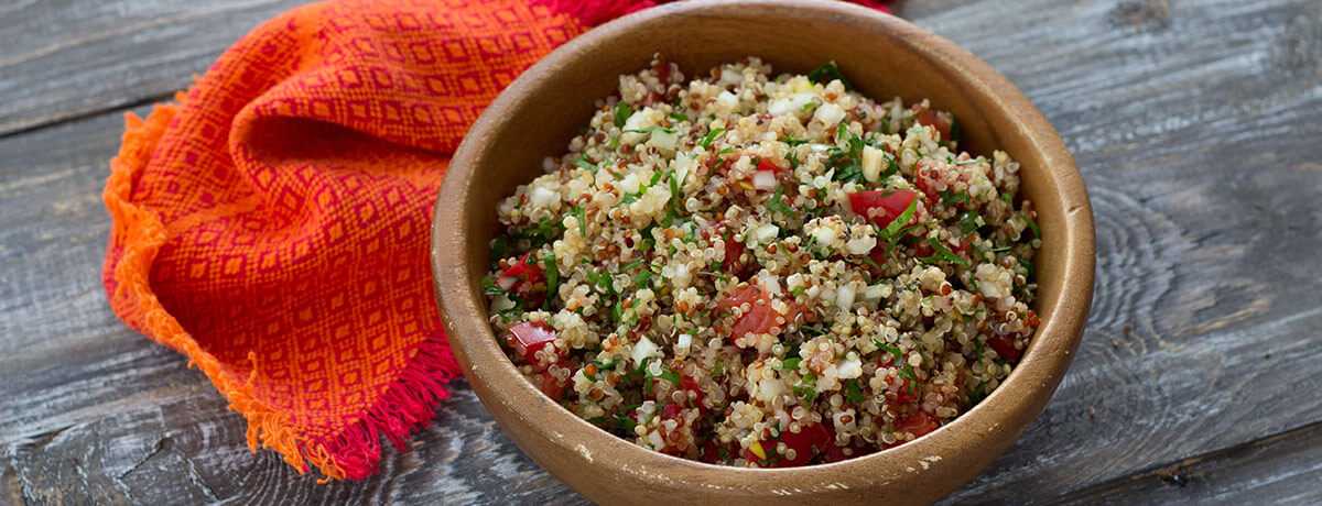 photo of a bowl of quinoa salad with parsley and tomatoes, one of many picnic food ideas