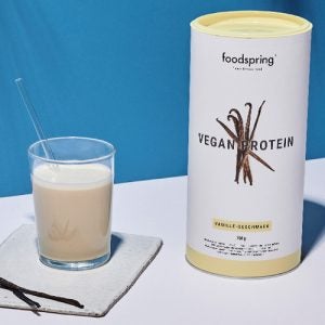 a canister of vanilla-flavored vegan protein powder