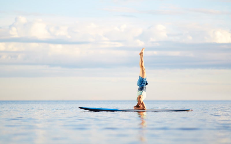 headstand on a paddle board