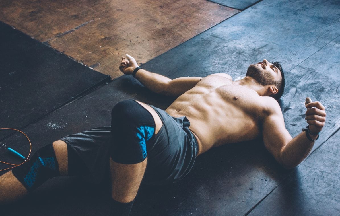 Young athlete resting in gym after hard cross training.