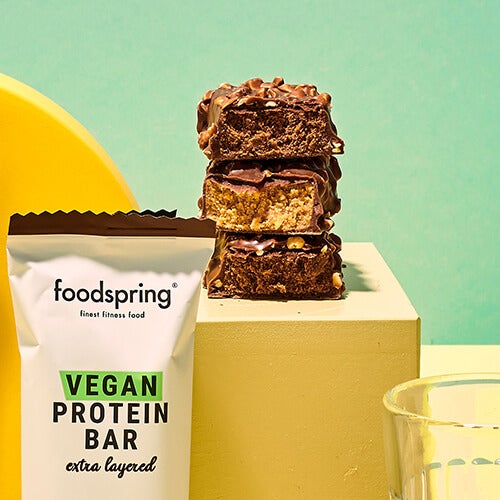 A photo of a stack of three Extra Layered Vegan Protein Bars, cut open to reveal their delicious insides