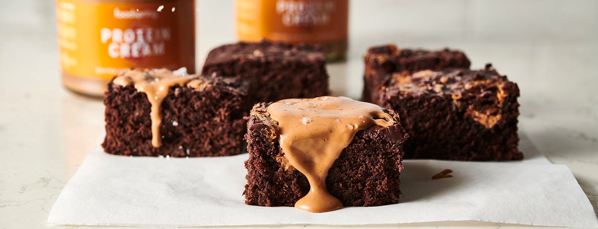Salted Caramel Brownies dripping with liquefied salted caramel protein cream