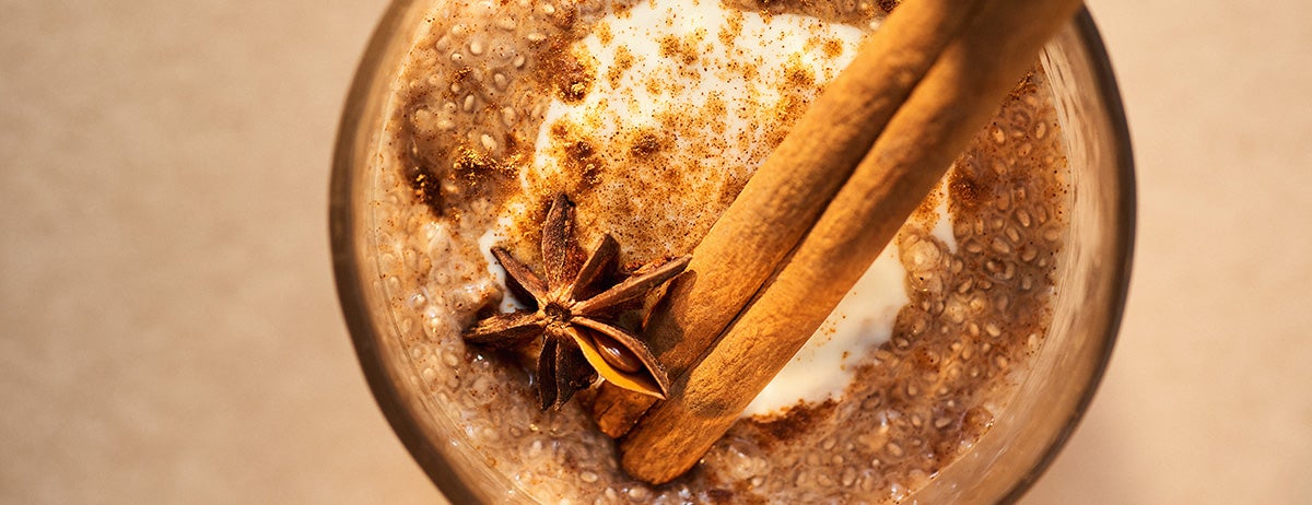 Chai Latte Chia Pudding dusted with cinnamon and topped with a cinnamon stick and a star of anise