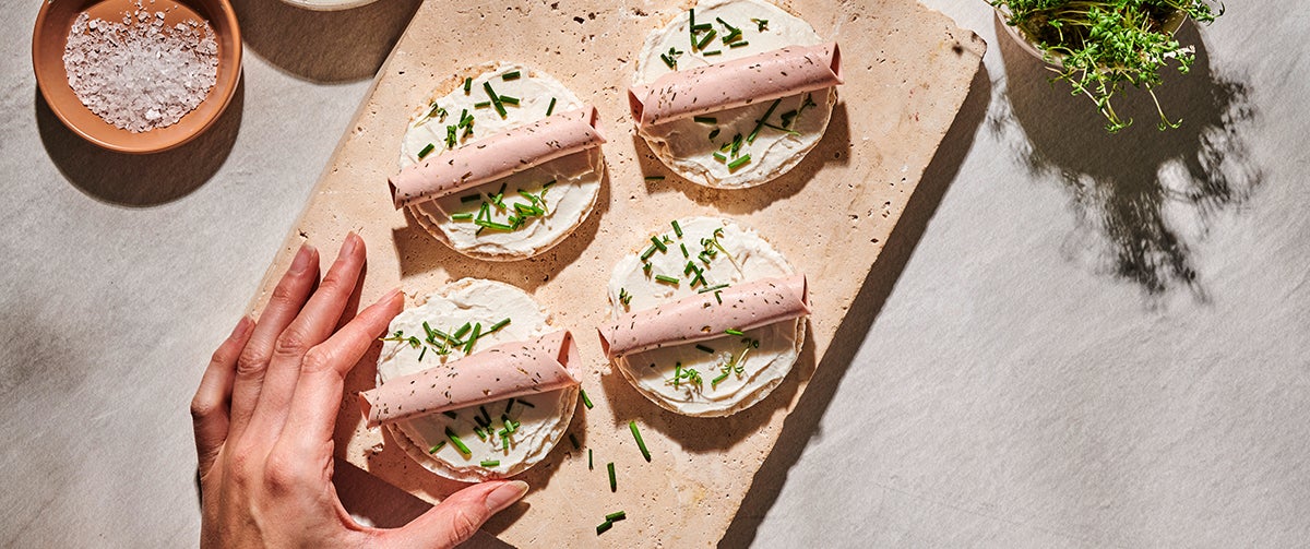 A granite cutting board holds decoratively topped rice cakes