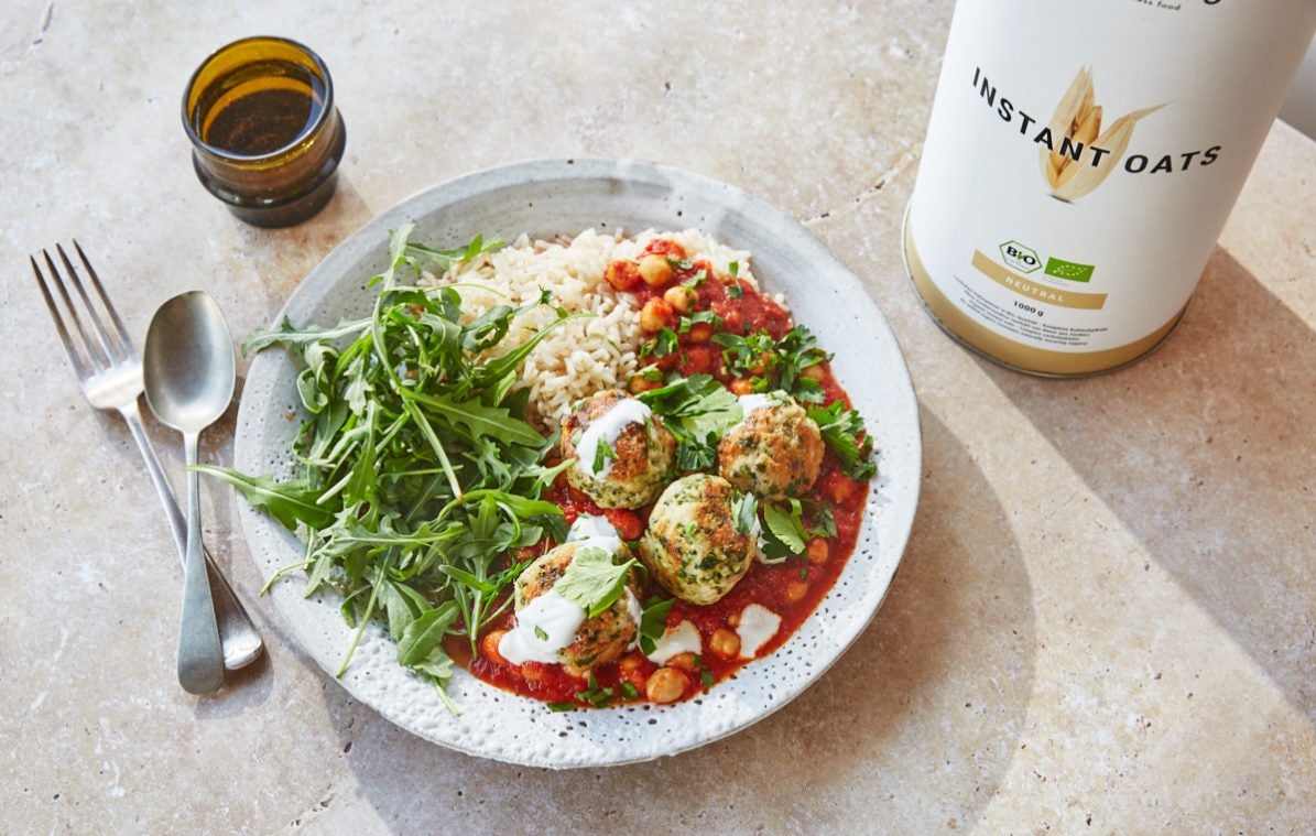 a bowl of turkey meatballs with harissa tomato sauce, rice and rocket