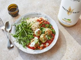 a bowl of turkey meatballs with harissa tomato sauce, rice and rocket