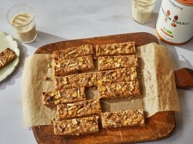 a board with high protein muesli bars and two glasses of milk