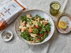 tuna pasta salad with rocket in a bowl