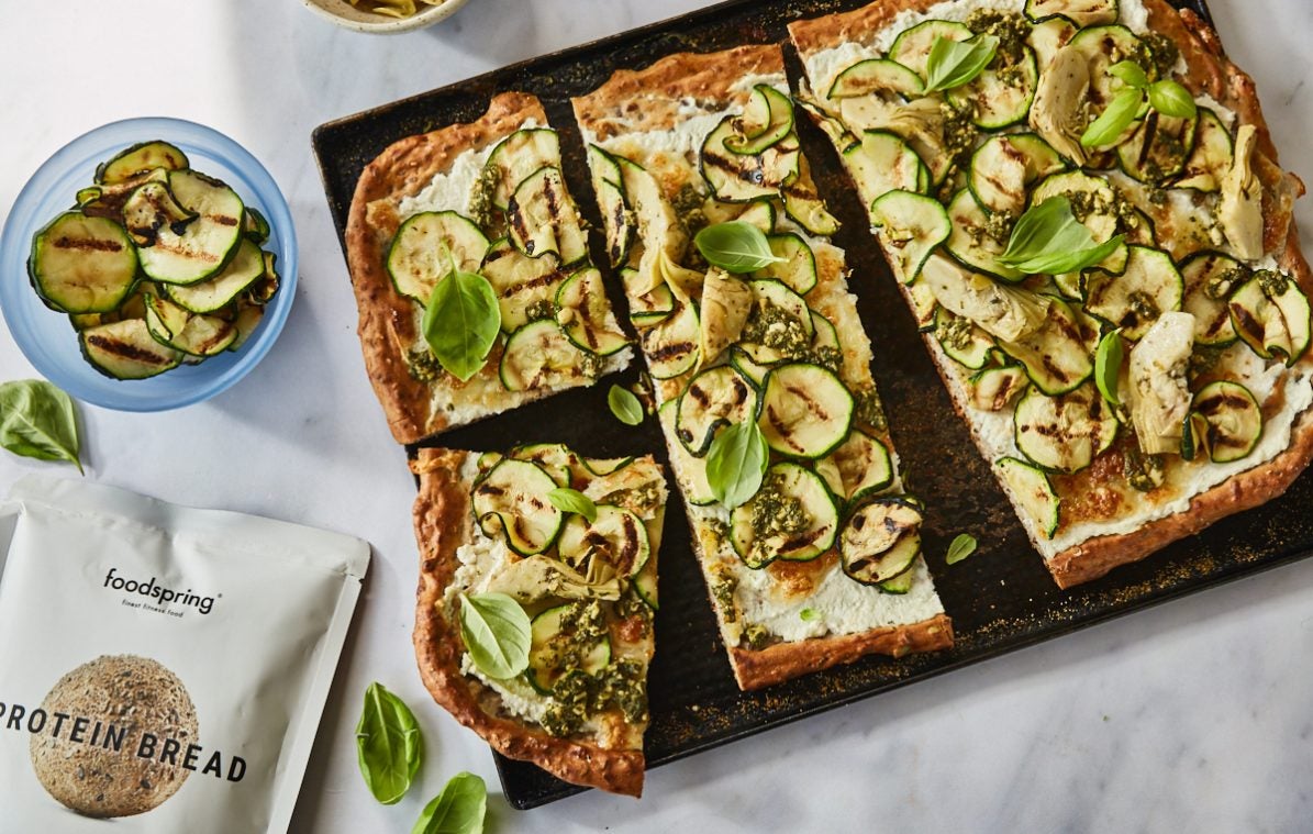 courgette flatbread with ricotta and artichokes on a tray