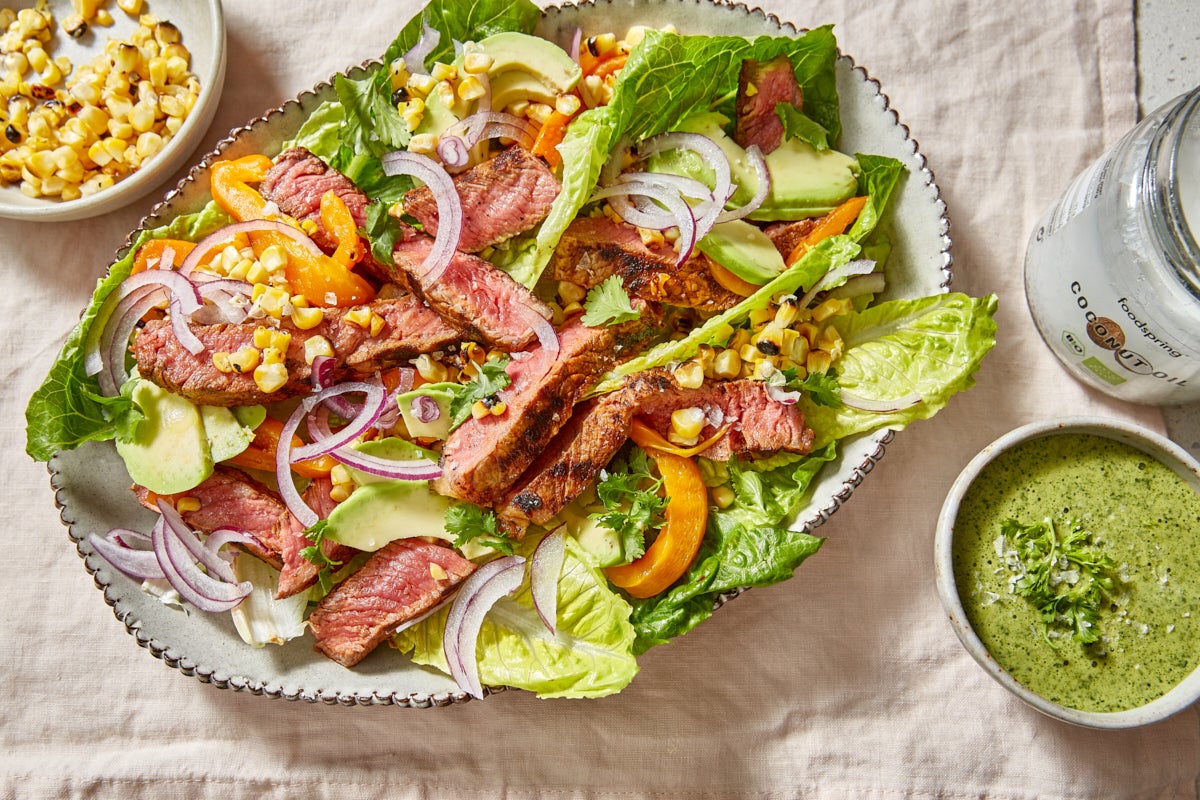 Salad plate with strips of meat arranged on a table